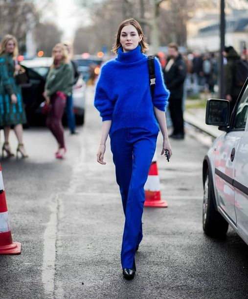 a statement classic blue outfit with an oversized sweater pants black booties and a comfy bag
