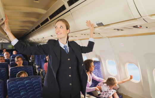 Why the cabin crew keep their arms behind their backs when greeting passengers22
